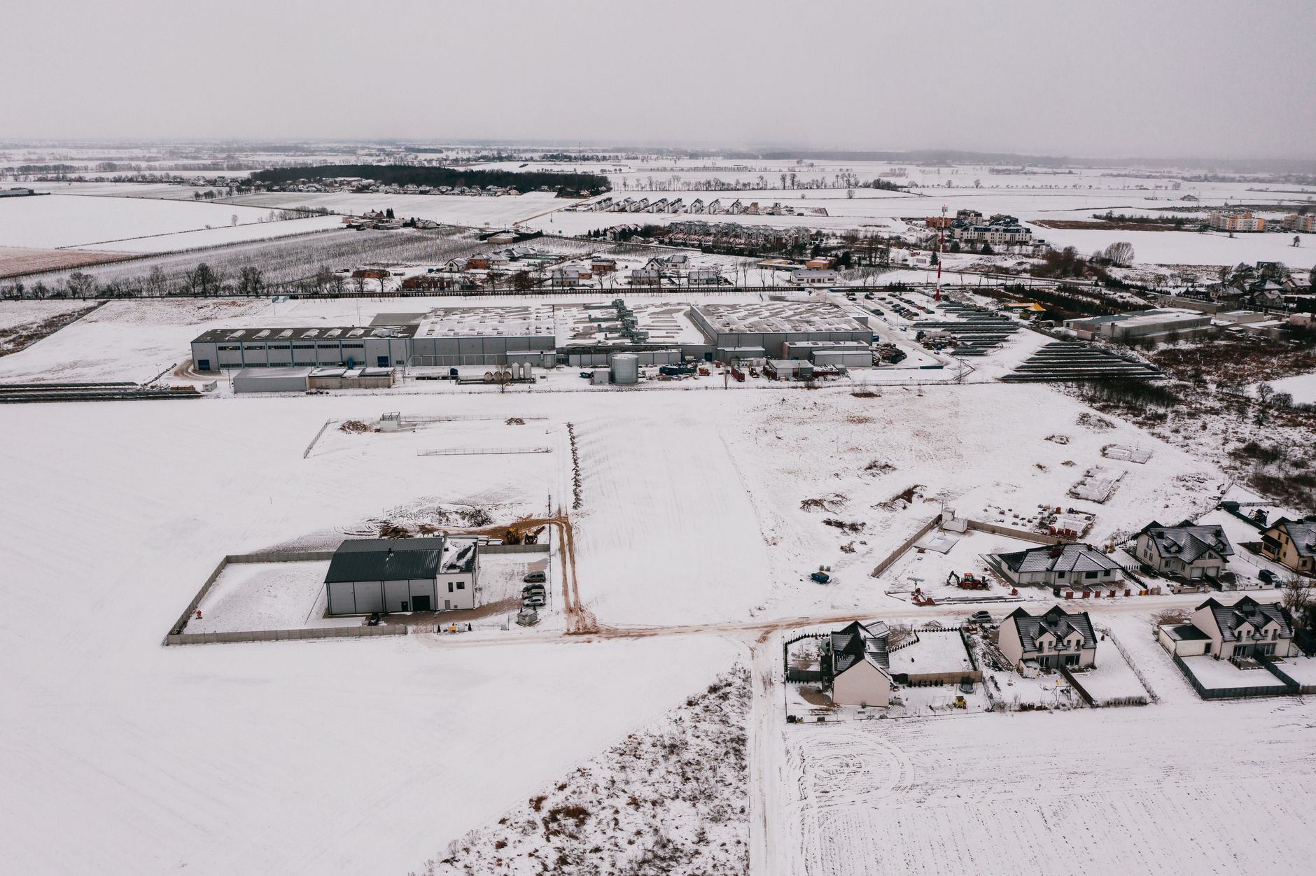 Drone shot of a snow-covered industrial estate in Poznań, Poland.