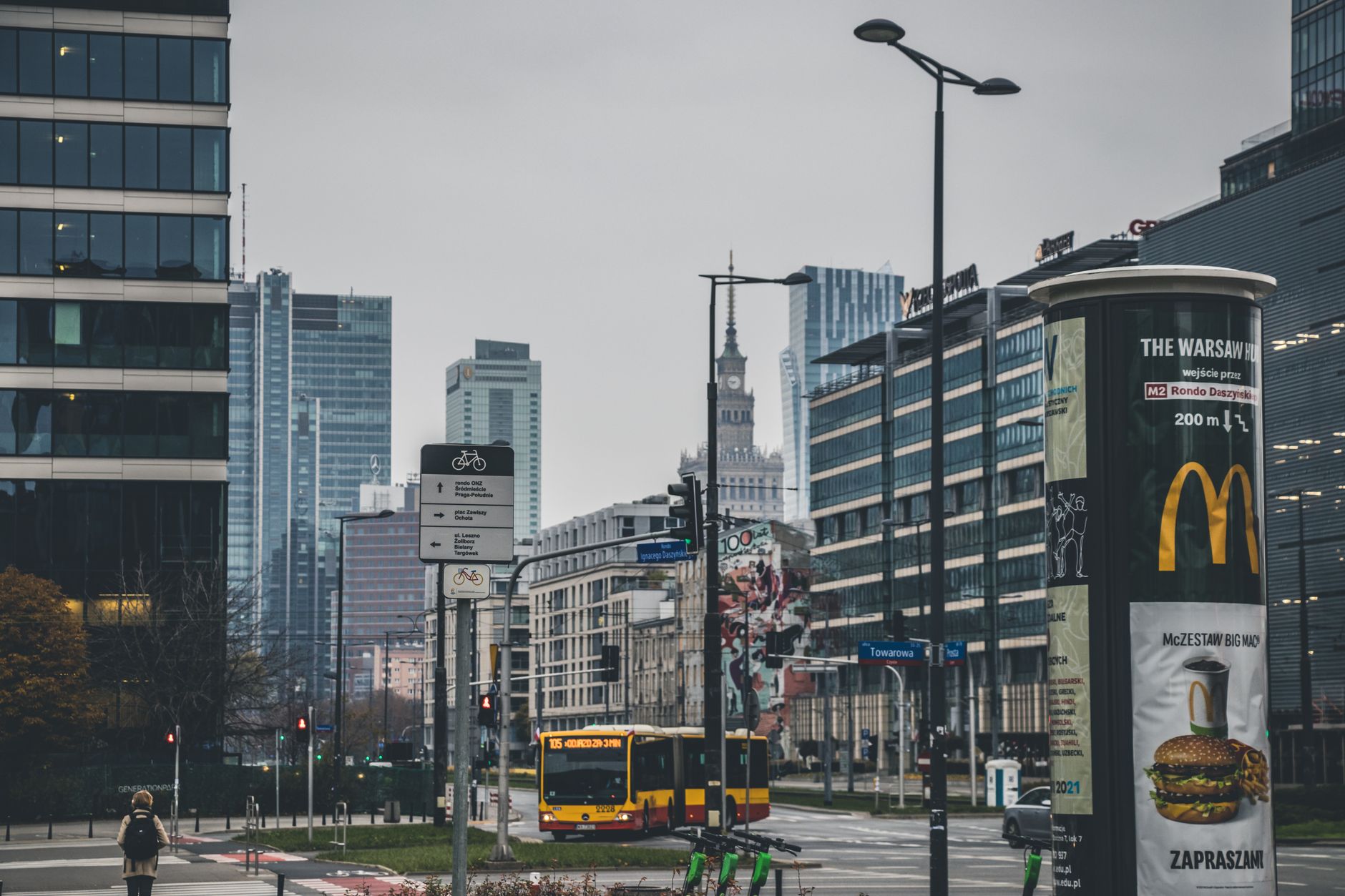 Modern cityscape of Warsaw, showcasing urban architecture and transportation on a cloudy day.