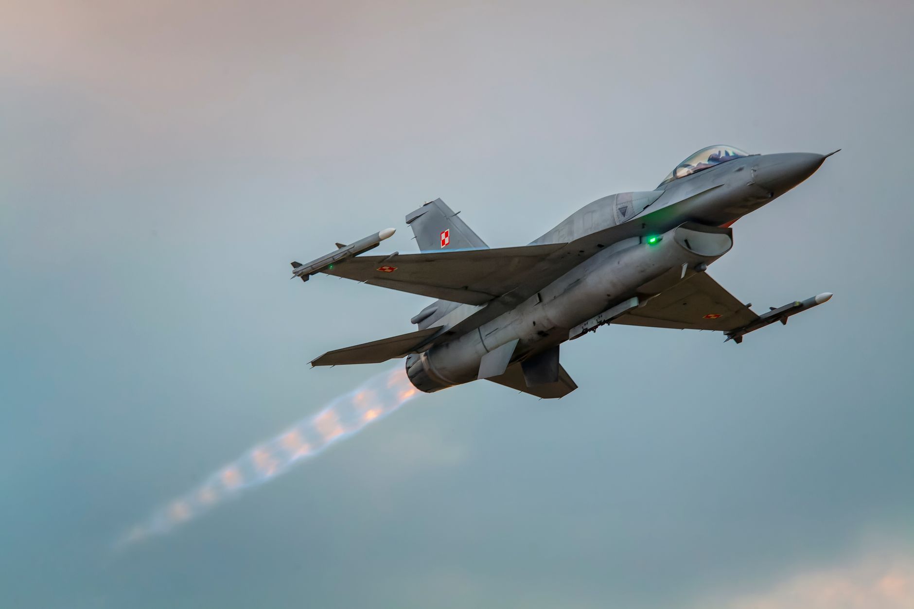 Dynamic capture of an F-16 Falcon jet soaring through the sky in Leszno, Poland.