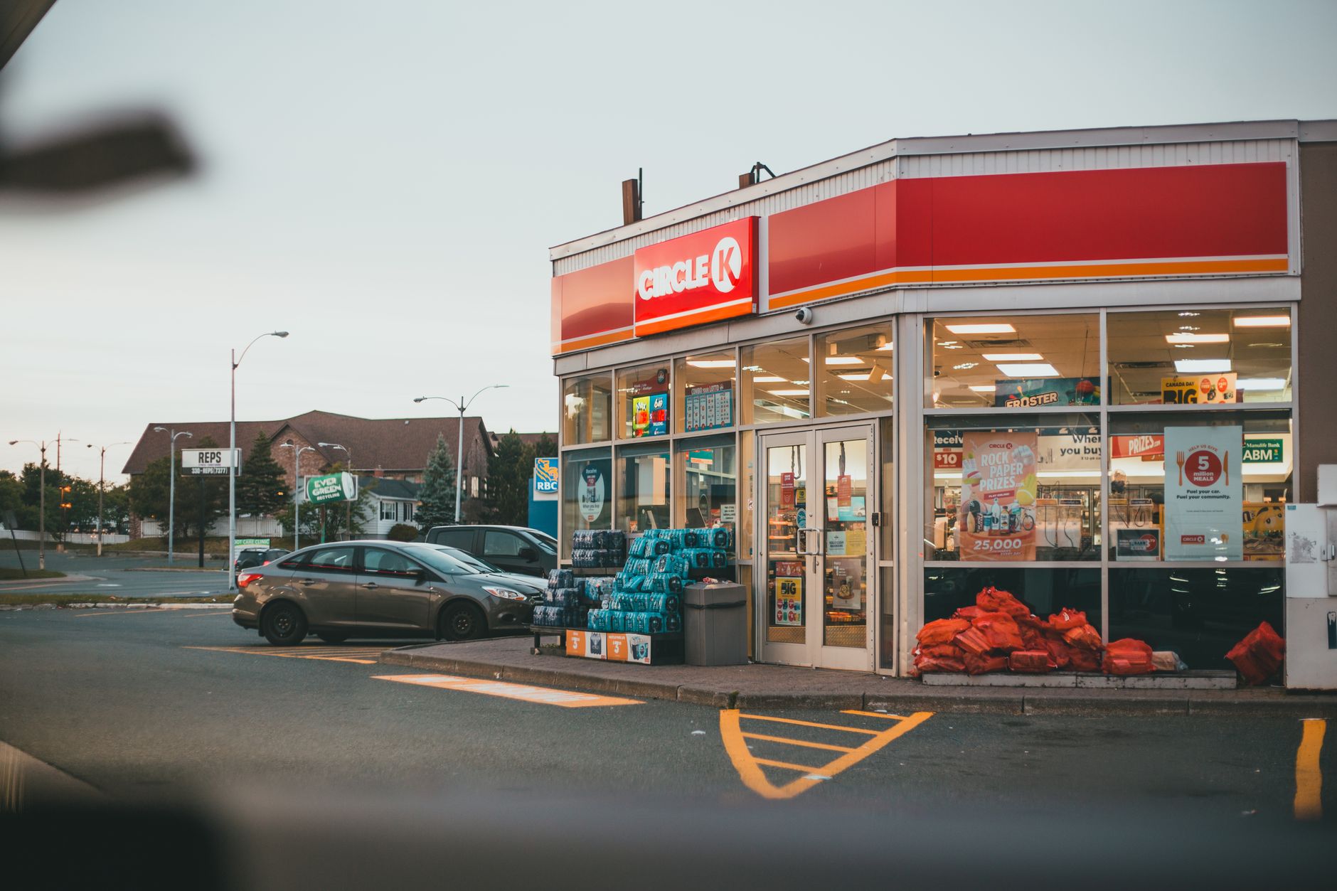 A Circle K gas station and convenience store in a city setting at dusk.