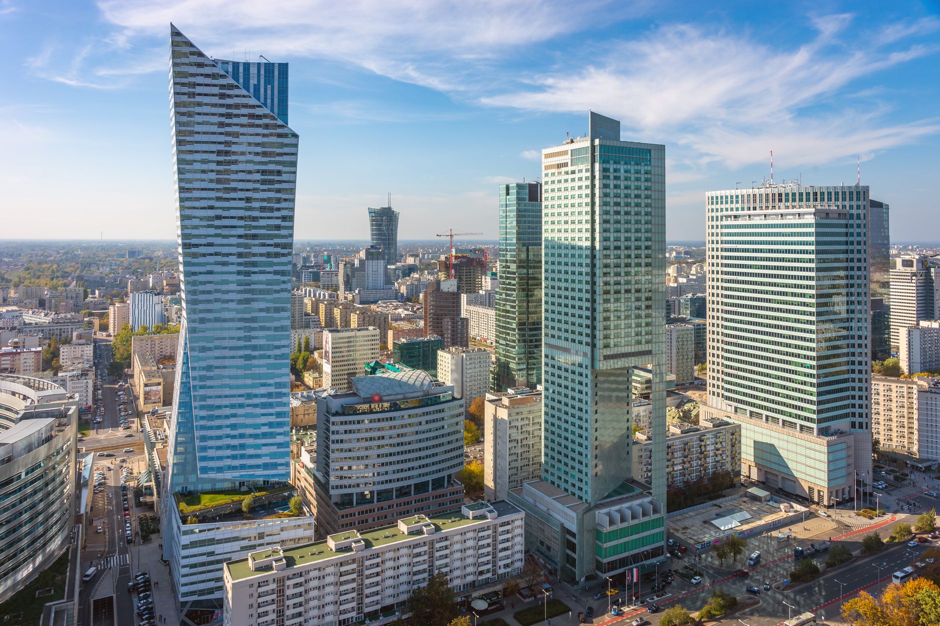 Aerial shot of modern skyscrapers in Warsaw's bustling financial district under a clear sky.