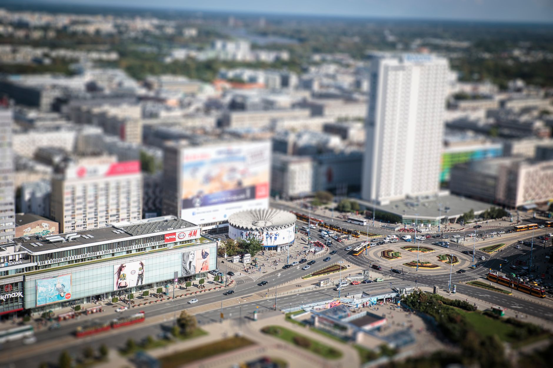 Tilt-shift aerial shot of downtown Warsaw capturing modern architecture and bustling streets.