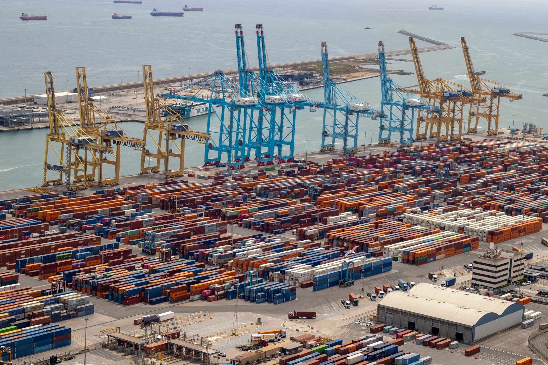 A bustling port with shipping containers and cranes, showcasing global trade.