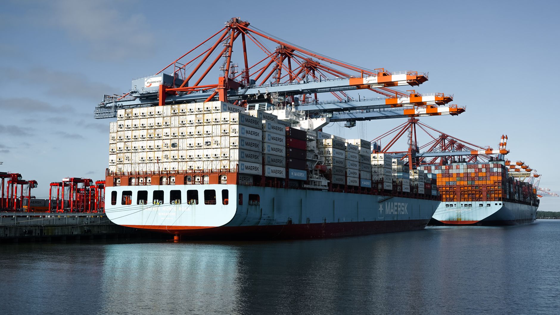 Aerial view of container ships docked at Hamburg port, showcasing logistics and global trade.